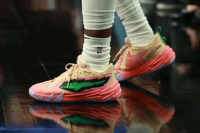 Portland Trail Blazers guard Scoot Henderson's pink and green PUMA shoes.
